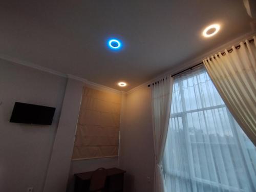 a room with a window and a light on the ceiling at Saira Hotel dan Homestay Syariah in Sleman