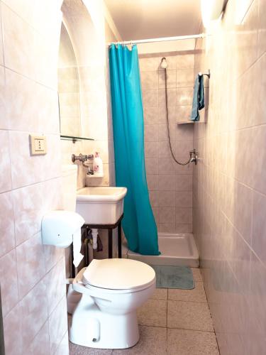 a bathroom with a toilet and a sink and a shower at Camurria Apartments in Giardini Naxos