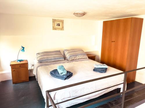 a bedroom with a bed with two towels on it at Camurria Apartments in Giardini Naxos
