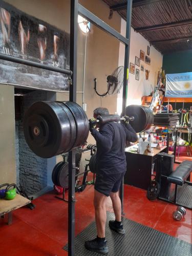 a man lifting a weight in a gym at HOSTEL DEL HERRERO in Apóstoles