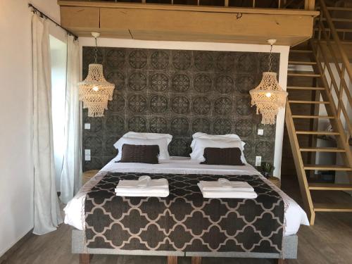 a bedroom with a large bed with two tables on it at Villa Vager Mani Hotel in Kalamata
