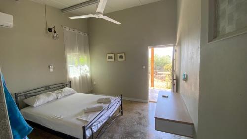 a bedroom with a bed and a window at Chelonaria in Kalamaki