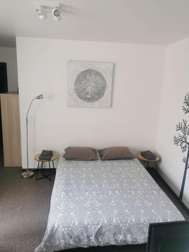 a bedroom with a bed and two end tables at Impasse 1 in Fosses-La-Ville