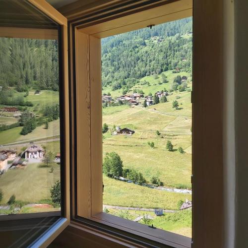 a window with a view of a green field at Al Doss in Rabbi