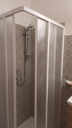 a shower with a glass door in a bathroom at Bed and Breakfast Rio Casaletto in Casaletto Spartano