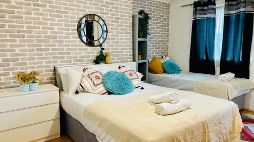 a bedroom with two beds with towels on them at Whites Inn in London