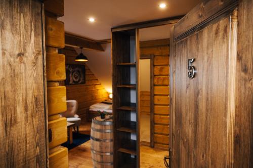 a door leading into a wine cellar with a barrel at Nestville Apartments in Hniezdne