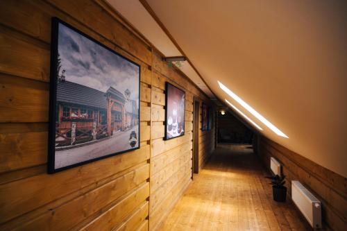a hallway with pictures on the walls of a building at Nestville Apartments in Hniezdne
