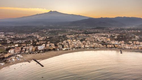 an aerial view of a beach with a city at Camurria Apartments in Giardini Naxos
