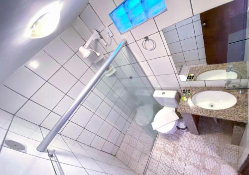 a bathroom with a toilet and a sink at Casarão Jeri in Jericoacoara