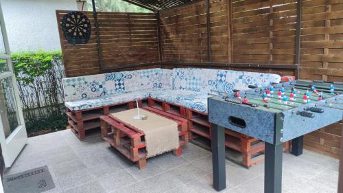 a ping pong table and a bench with a chess board at T-Lak Vendégház Tiszalök in Tiszalök