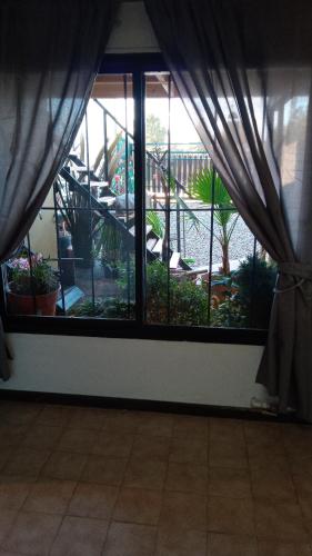 a room with a window looking out at a garden at MiDpto2 in San Carlos de Bariloche