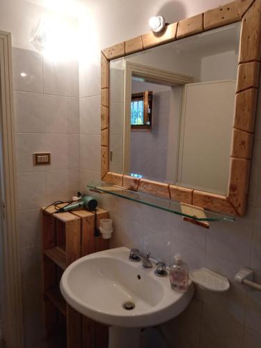 a bathroom with a sink and a mirror at Casa Vacanze Le Macchie in Parabita