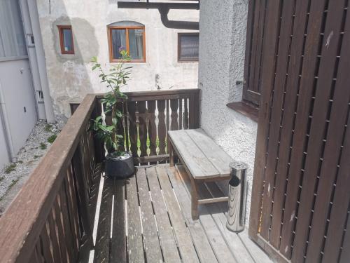 a wooden porch with a bench and a window at Cosy Forest in Kranjska Gora