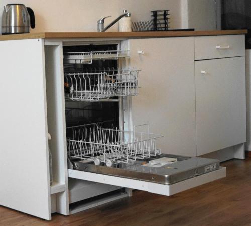 a kitchen with dishes in an open dishwasher at Mathilde in Ybbs an der Donau