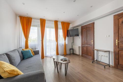 a living room with a couch and a table at Street'n Apartment in Budapest