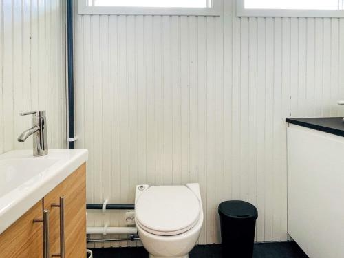a bathroom with a white toilet and a sink at Holiday home TORSLANDA IV in Torslanda