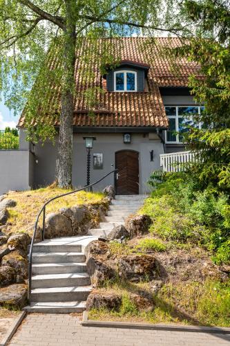a house with stairs leading up to a door at Kadriorg by Rikas Hotels in Tallinn