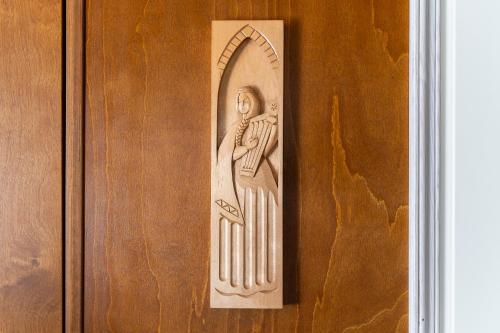 a wooden door with a carving of a woman on it at Kadriorg by Rikas Hotels in Tallinn