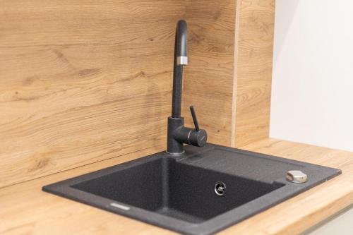 a kitchen sink with a faucet on a counter at VacationClub – Zdrojowa 7 Apartament 11 in Duszniki Zdrój