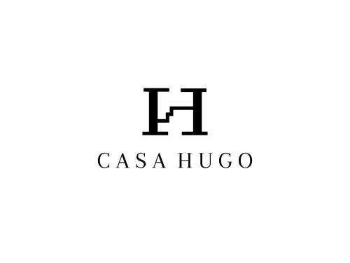 a logo for a casa hugo restaurant at Casa Hugo - Guest Suites in Fort-de-France