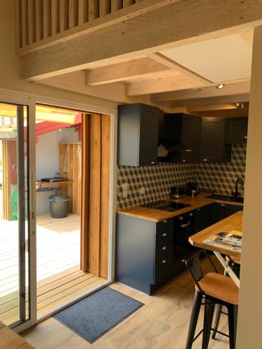 a kitchen with a sliding glass door leading to a deck at Les gites du canal in Gujan-Mestras