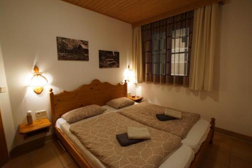 a bedroom with a large bed with two pillows on it at Ferienapartment Candy auf der Gerlitzen in Treffen