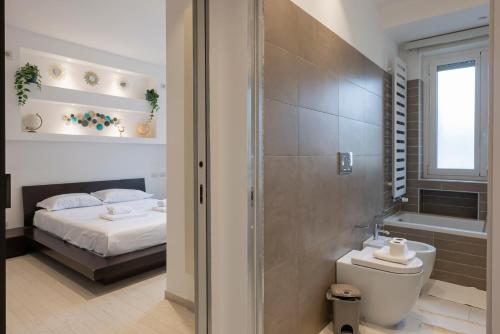 a bedroom with a bed and a tub and a toilet at [IHost Apartment] - Tito Livio 20 in Milan