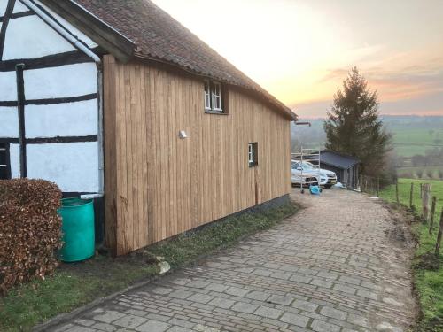 a large wooden building with a driveway next to it at Oud-Bommerich in Mechelen