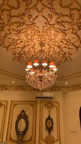 a chandelier hanging from a ceiling in a room at Vila XVIP in Ras al Khaimah