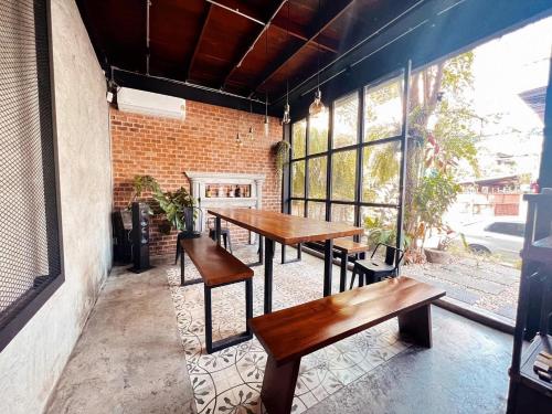 a group of tables and benches on a patio at The LOCAL Ari in Bangkok