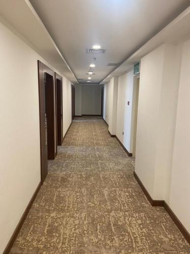 an empty hallway of an office building with a long corridor at Dolphin Continental Hotel in Kuwait