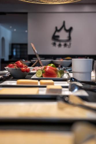 a table with plates of food on it at Hotel Royal in Sesto