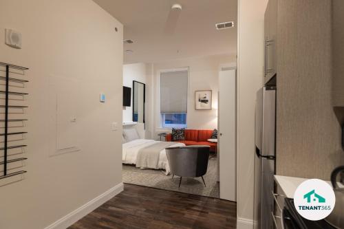 a bedroom with a bed and a living room at Inner Harbor's Best Luxury Furnished Apartments apts in Baltimore