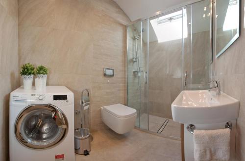 a bathroom with a washing machine and a sink at Apartment Split Belvedere in Split