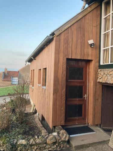 a wooden building with a door on the side at Oud-Bommerich in Mechelen