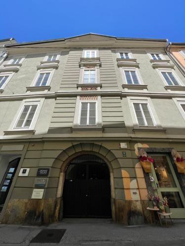 a large building with an archway in front of it at Apartment Zum Dom in Graz