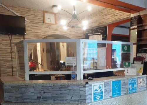 a store checkout counter with a large window at Hotel Imperial Jojutla in Jojutla de Ju&aacute;rez