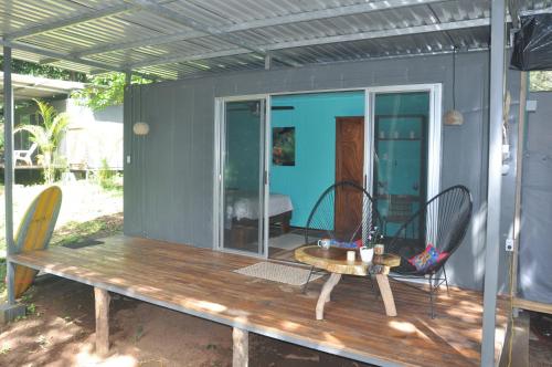 a table and chairs sitting outside of a house at Alegria River Hideaway and Retreats in Cuajiniquil