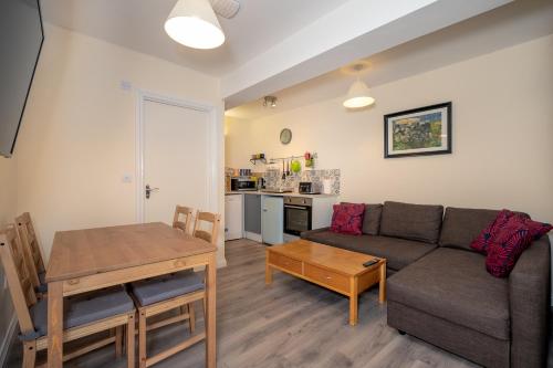 a living room with a couch and a table at The Ramblers' Rest - Princetown in Princetown