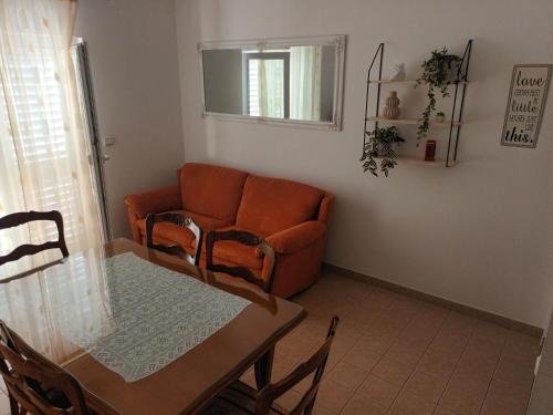 a living room with a couch and a table at Apartments Drago Kovačić in Omiš