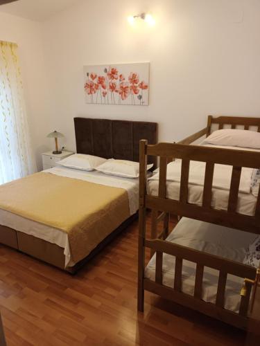 a bedroom with two bunk beds in a room at Apartments Drago Kovačić in Omiš