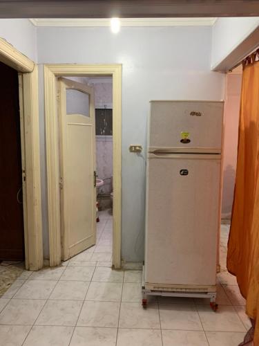 a kitchen with an old refrigerator in a room at Azzam Guest House 1 families only in Fayoum