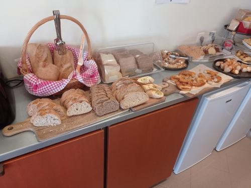 a counter with a bunch of different types of bread at Alexandros Studios in Kalamaki Chanion