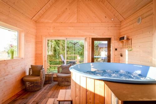 a large bathroom with a tub in a wooden house at Ośrodek Wypoczynkowy Bernadetta in Murzasichle