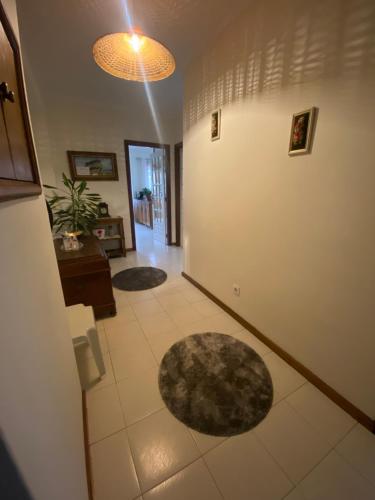a room with a hallway with rugs on the floor at Apartamento T3 Amorosa in Viana do Castelo
