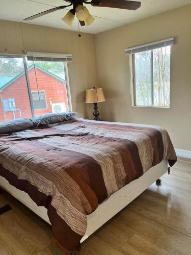 a bedroom with a large bed and a ceiling fan at Outback Campground and Marina in Trinity