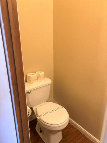 a bathroom with a toilet and two rolls of toilet paper at Outback Campground and Marina in Trinity