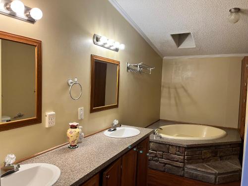 a bathroom with two sinks and a tub at Outback Campground and Marina in Trinity