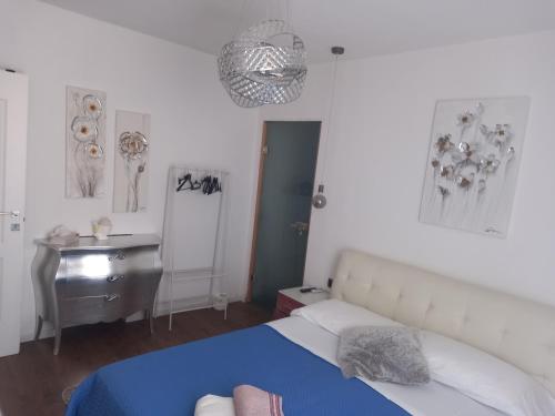a bedroom with a bed and a desk and a mirror at Arena in fiera in Verona